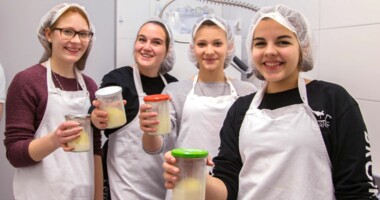 Vier Teenagerinnen präsentieren stolz ihre selbstgemachte Butter